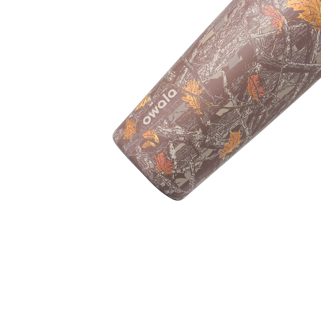 Owala SmoothSip Slider 20oz in Out of Sight, body close-up showing oak-leaf camouflage pattern in browns and greys with cream owala wordmark